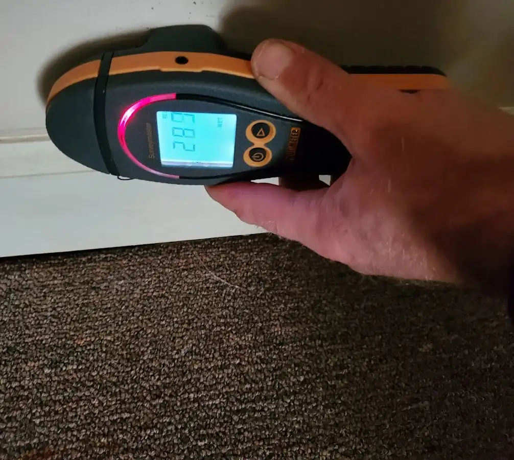 Moisture detection at baseboard during Storm Damage Restoration in Benton